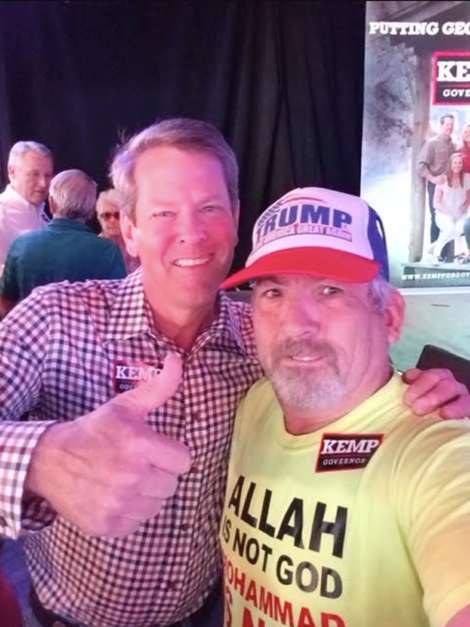 Illustration for article titled White Nationalist Who Threatened Stacey Abrams' Campaign Poses for Picture With Brian Kemp